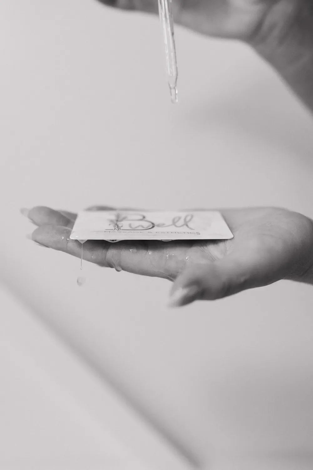 A B Well gift card held in an open hand