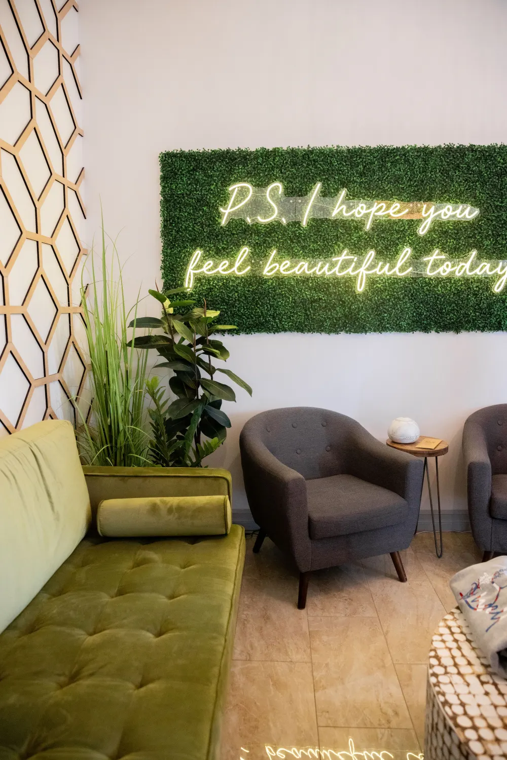 B Well lobby with a neon sign that reads P.S. I hope you feel beautiful today