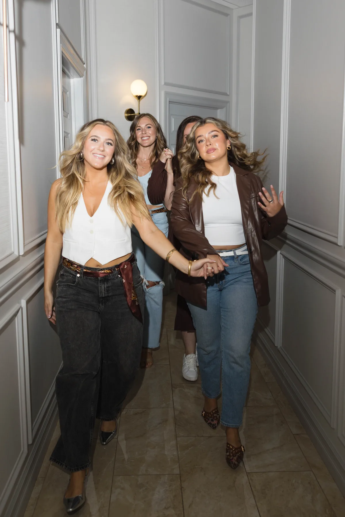 B Well team members walking down the spa hallway